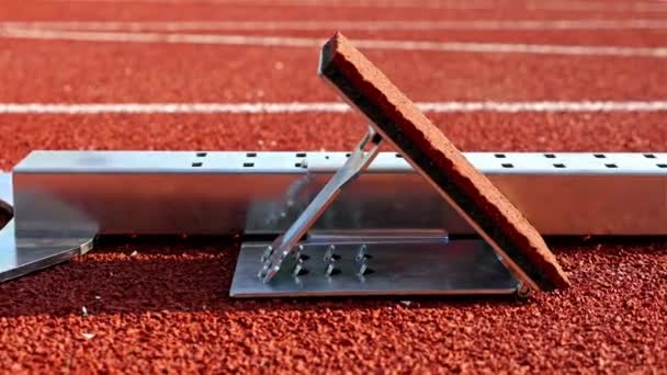 Starting block for a track and field sprinter in a stadium — Stock Video