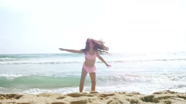 Linda niña en traje de baño jugando en la playa del mar — Vídeos de Stock