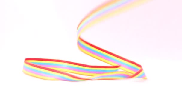 Gymnast girl waves ribbon in studio with white background — Stock Video