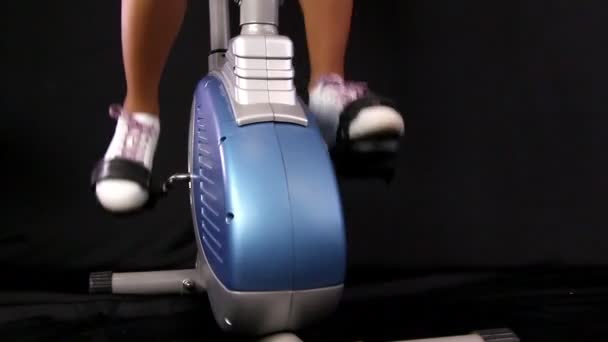 Close up of a young woman riding stationary bike — Stock Video