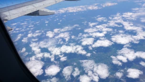 Airplane window view to the blue sky and clouds. Transportation — Stock Video