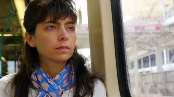 Woman using smart phone while traveling in a railway train in London — Stock Video