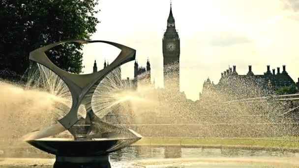 View to Big Ben, House of parliament and Westminster bridge in London with a fountain in front of them