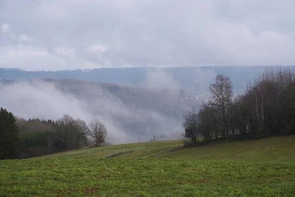 Landscape photo in rainy weather with fog and clouds in spring.