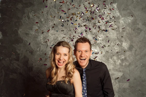 Celebrate holiday with tinsel salute, portrait of young couple — Stock Photo, Image