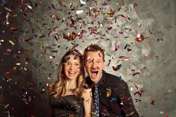 Celebrate holidays with tinsel salute, portrait of young couple — Stock Photo, Image