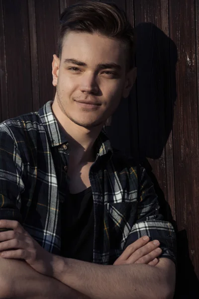 Close-up fashion portrait of handsome man near wood wall outdoor — Stock Photo, Image