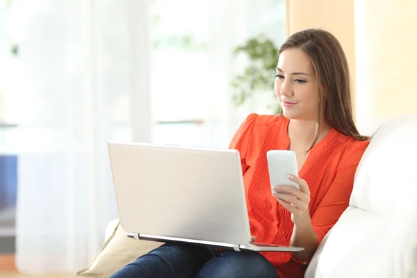 Woman working with laptop and phone — Stock Photo, Image