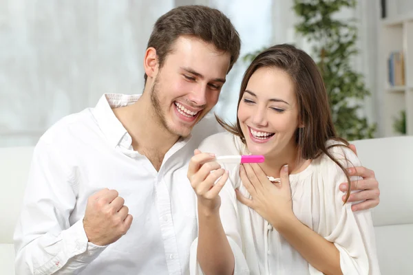 Happy couple making positive pregnancy test — Stock Photo, Image
