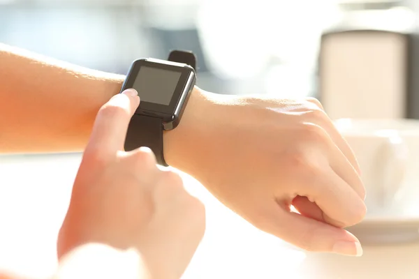 Femme mains à l'aide d'une montre intelligente dans un bar — Photo