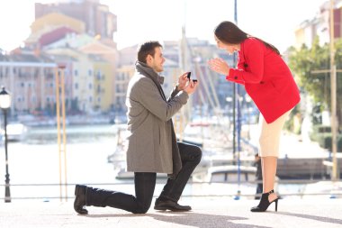 Proposal of man asking marry to his girlfriend clipart