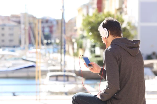 Teenager listening music from smart phone
