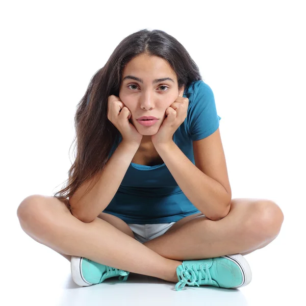 Bored teenager girl sitting with crossed legs — Stock Photo, Image