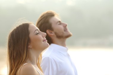 Couple of man and woman breathing deep fresh air clipart