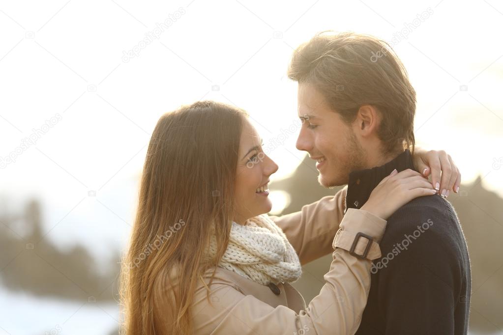 Back light of a couple looking each other