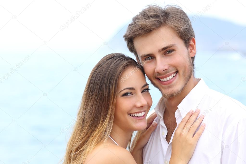 Happy couple with a white smile looking at camera