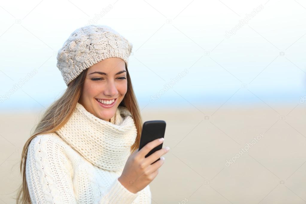 Woman in winter using a smart phone