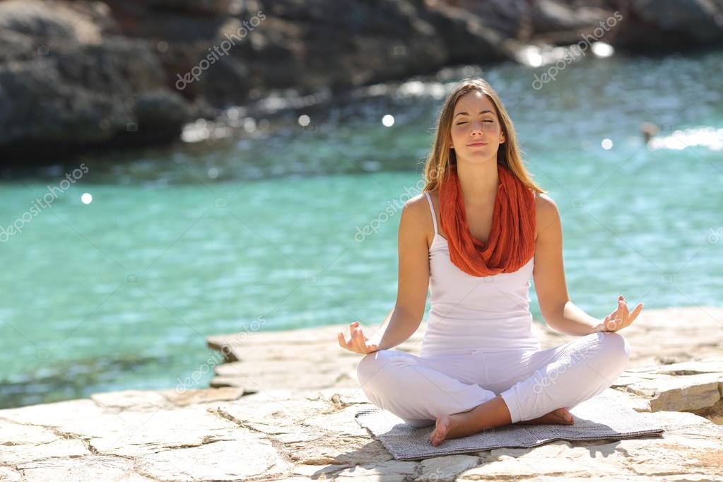 Relaxed girl doing yoga exercises on holidays