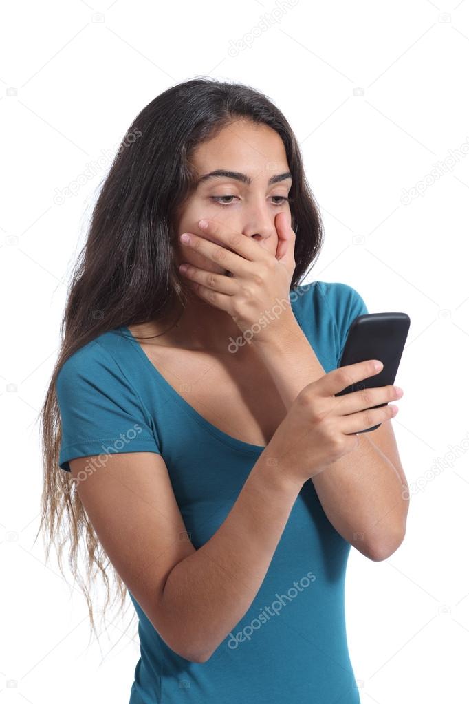 Worried teenager girl looking at smart phone
