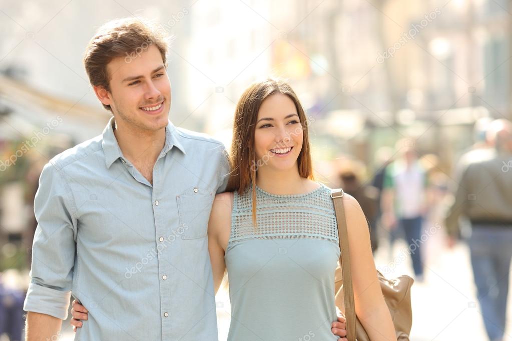 Couple of tourists walking in a city street