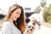Картина, постер, плакат, фотообои "girl texting on a smart phone in a train station", артикул 73762679