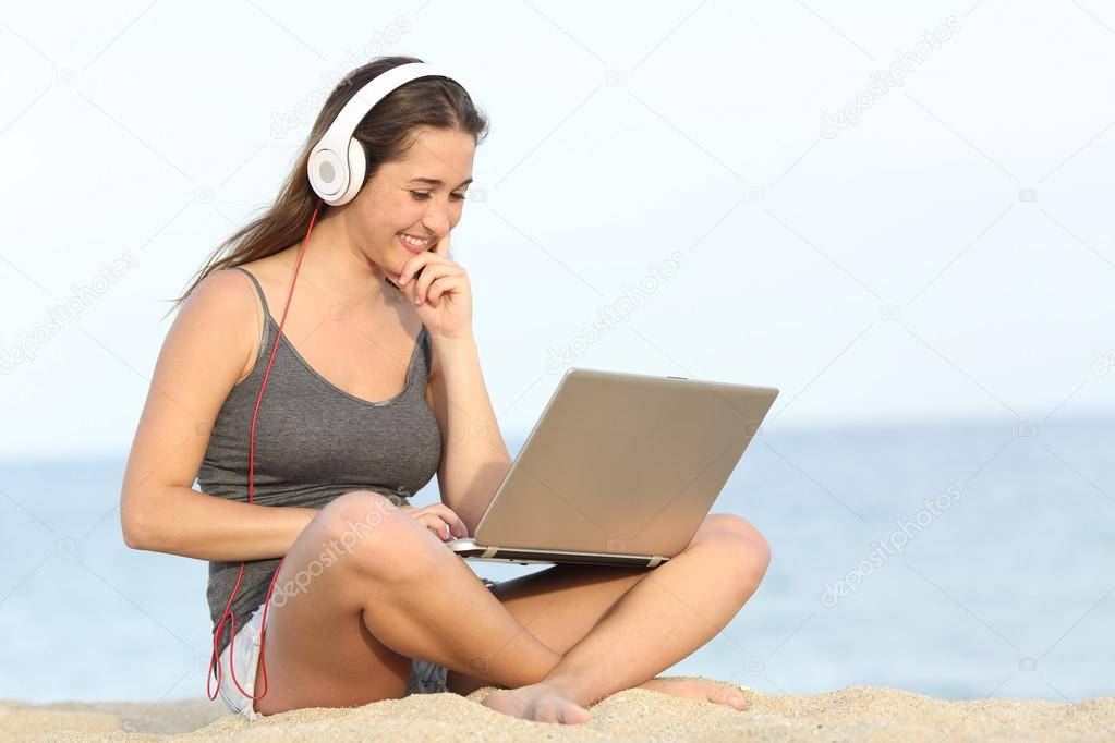 Student learning course with a laptop on the beach