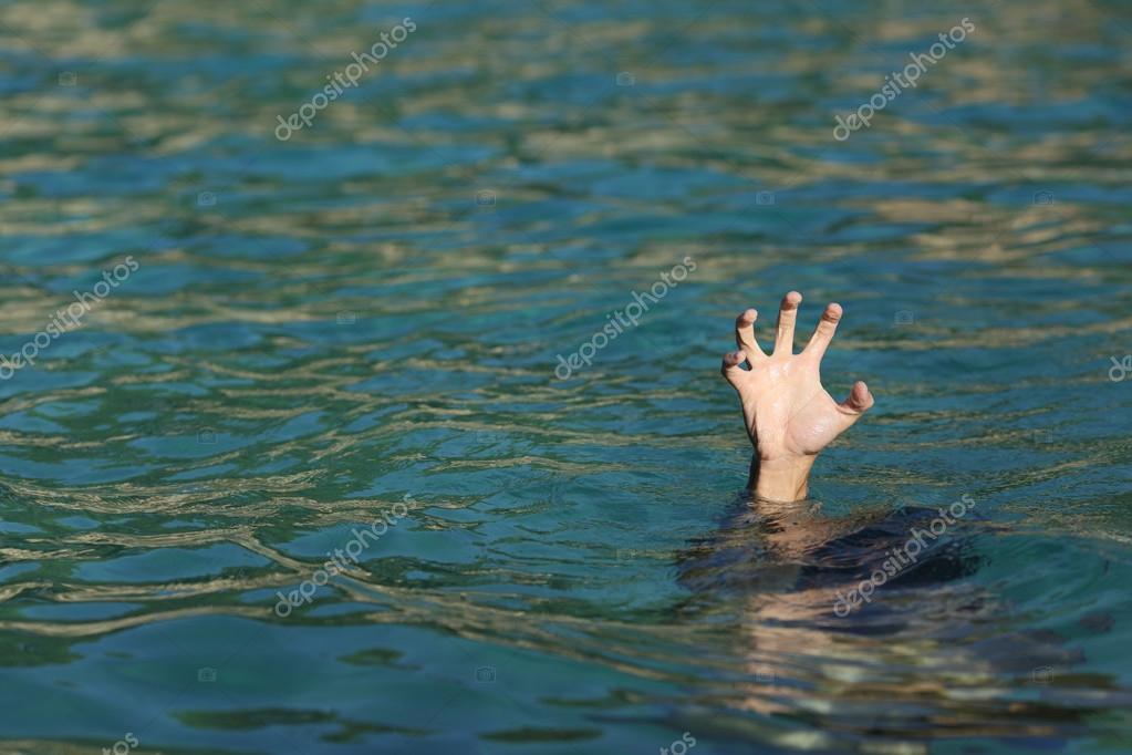 Man hand drowning in the ocean Stock Photo by ©AntonioGuillemF 82238040