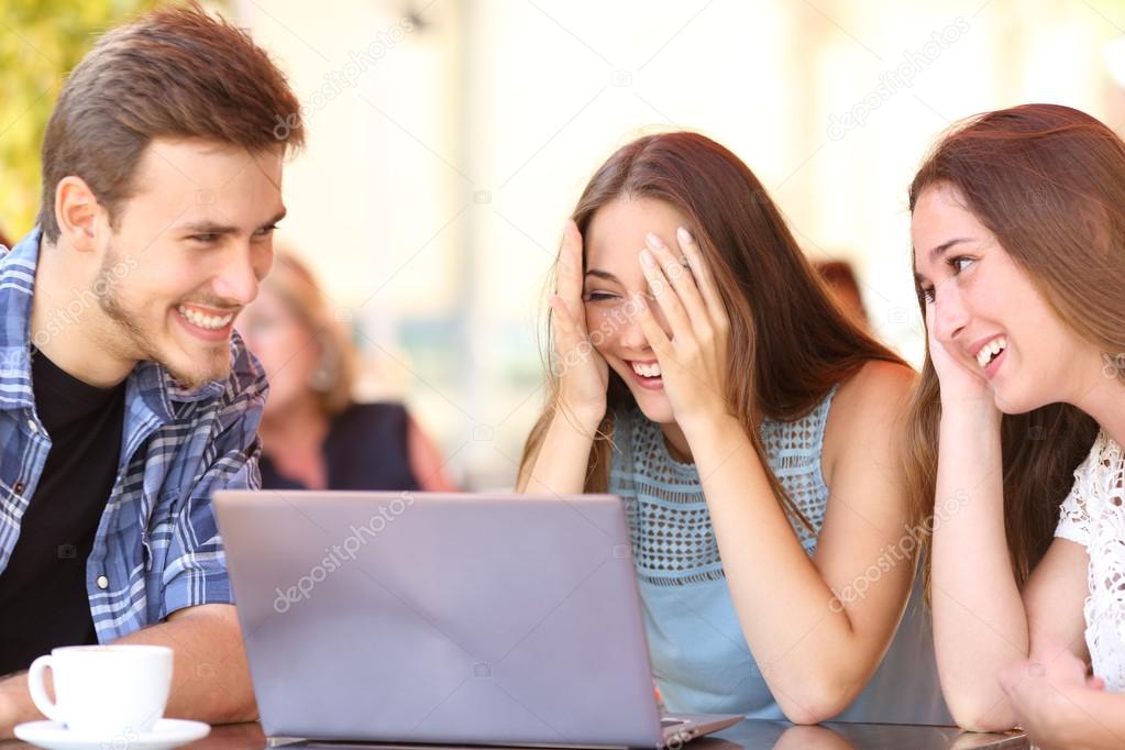Friends giving a laptop gift to a surprised girl