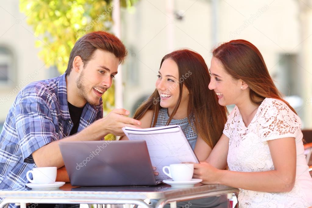 Three students studying and learning in a coffee shop