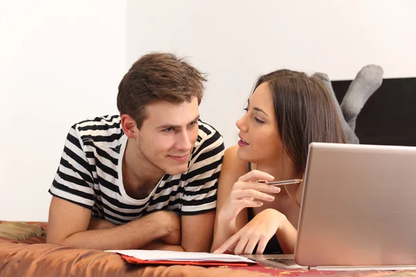 Estudantes aprendendo em casa com um laptop e notas — Fotografia de Stock