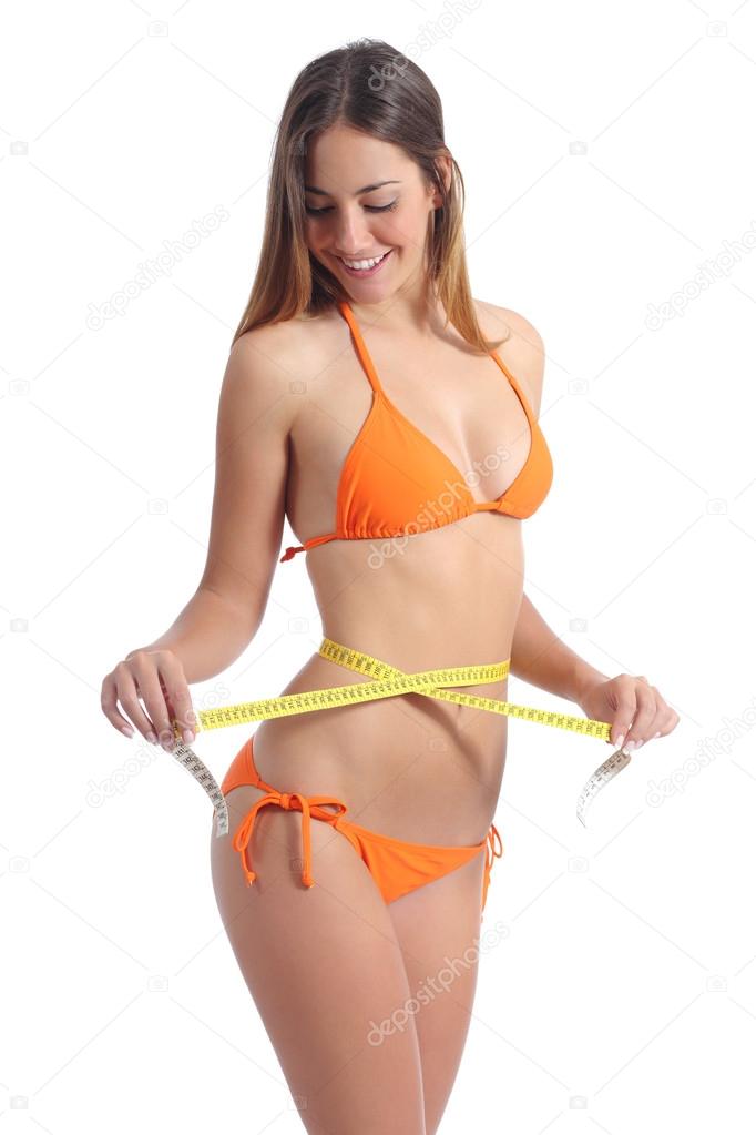 Pretty Caucasian woman measuring her waist measuring tape