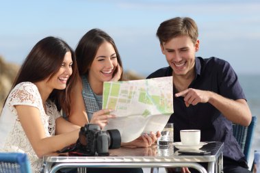Grup genç turist arkadaşıyla bir kağıt harita danışmanlık