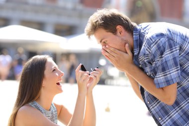 Proposal of a woman asking marry to a man clipart