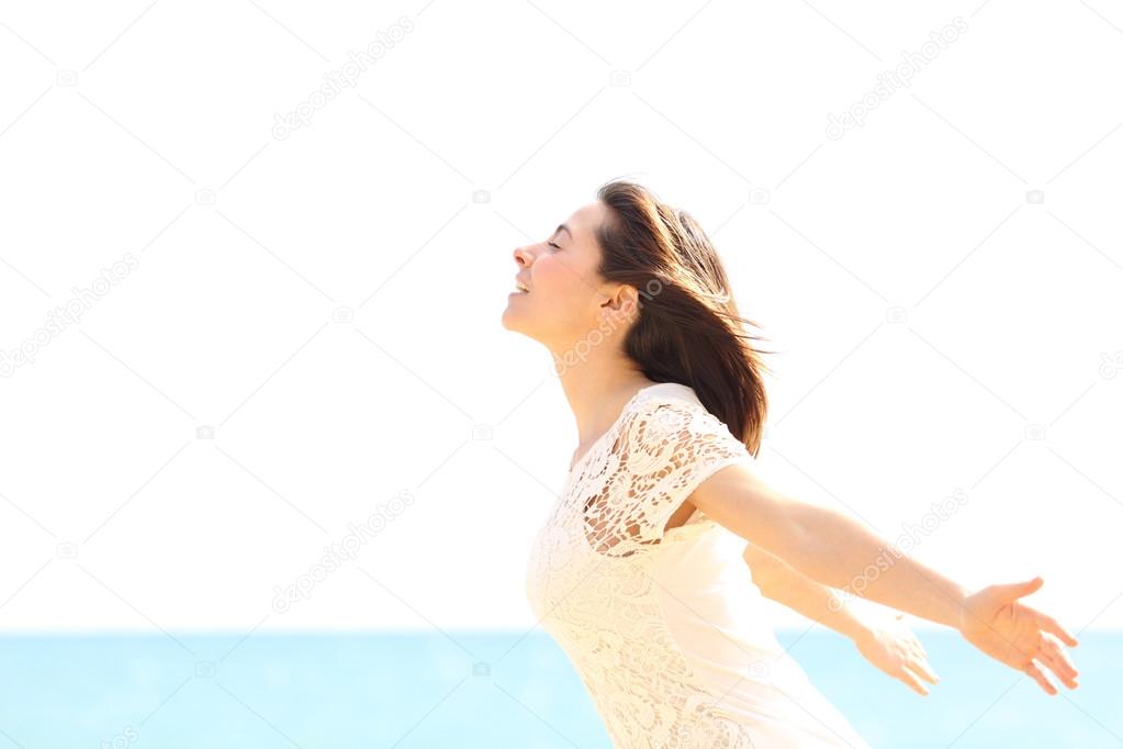 Happy woman enjoying the wind and breathing fresh air