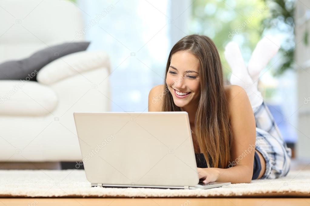 Girl online browsing a laptop at home