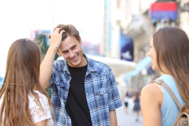 Young man flirting with two girls clipart