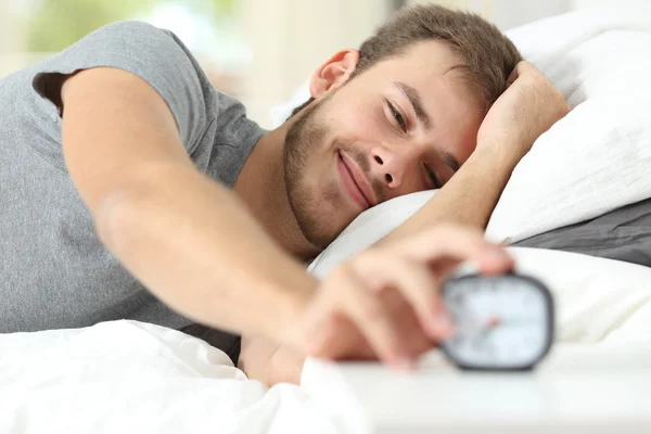 Happy wake up of a happy man stopping alarm clock — Stock Photo, Image