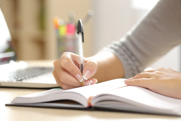 Woman hand writing in an agenda at home Stock Picture