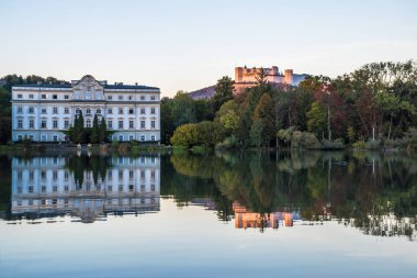 Leopoldskroner Weiher Gölü 'nde güzel günbatımı renkleri ve arka planda Leopoldskron Sarayı ve Hohensalzburg Kalesi - Salzburg, Avusturya 