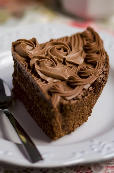 Chocolate coffee cake with chocolate cream decoration on the white plate — Stock Photo, Image