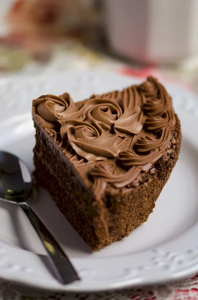 Chocolate coffee cake with chocolate cream decoration on the white plate — Stock Photo, Image