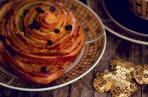 Danish orange and chocolate drops puff pastry with teddy bear decoration — Stock Photo, Image