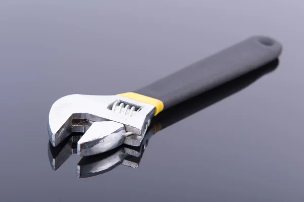 Wrench on a black table — Stock Photo, Image