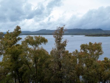 Gabriel galn reservoir water with trees and cloudy sky