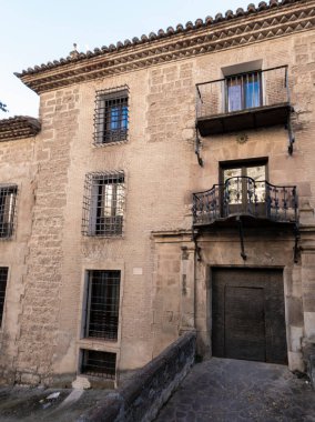 Demirden yapılmış balkonları ve Toledoraw 'daki antik girişi olan tarihi taş bina cephesi.