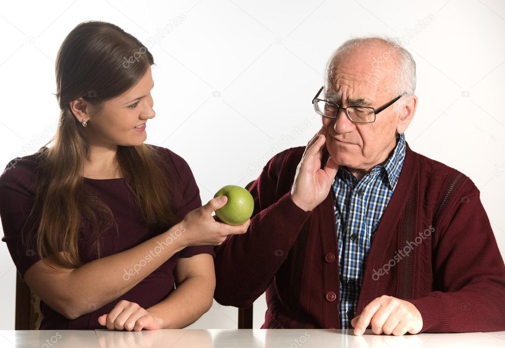 young woman helps senior man