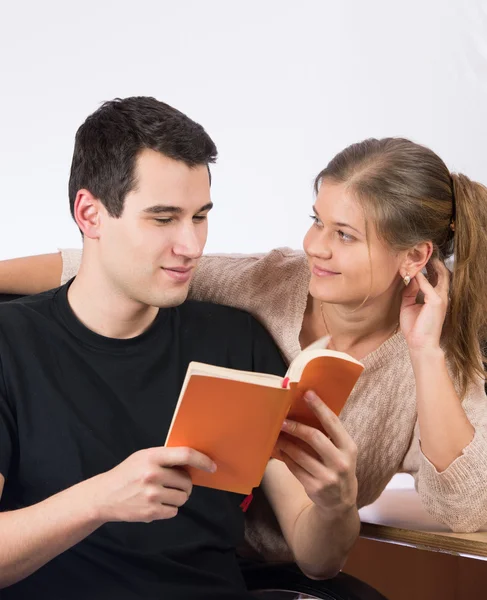 Couple in office reading a book — Stock Photo, Image