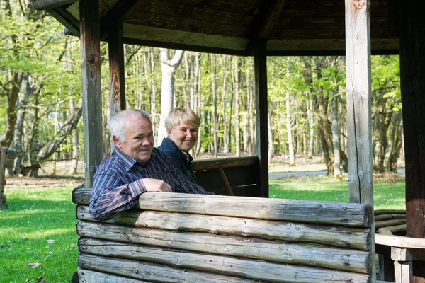 Older people sitting in the arbor — Stock Photo, Image
