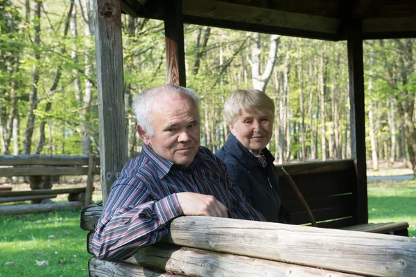 Older people sitting in the arbor — Stock Photo, Image