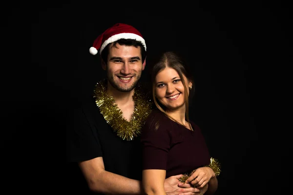 Young couple on black background — Stock Photo, Image